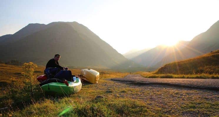 Outdoor Education and Paddlesport. A paddler sits in a kayak in the countryside.