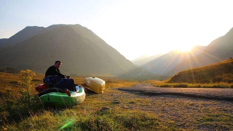 Outdoor Education. A paddler sits in a kayak in the countryside.