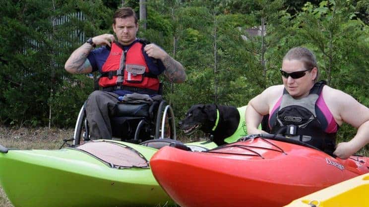 Paddle-Ability. A paddler in a wheelchair is getting ready to go paddling.