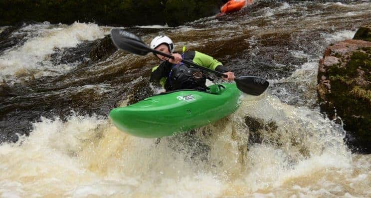White Water Kayak Leader. A paddler going of a small drop in white water.