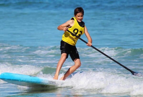 Boy on a paddleboard at sea. British Canoeing Safeguarding Refresher Social Media eLearning