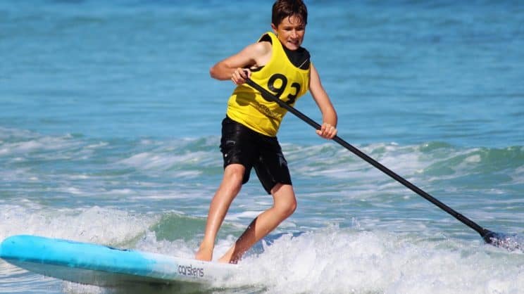Boy on a paddleboard at sea. British Canoeing Safeguarding Refresher Social Media eLearning